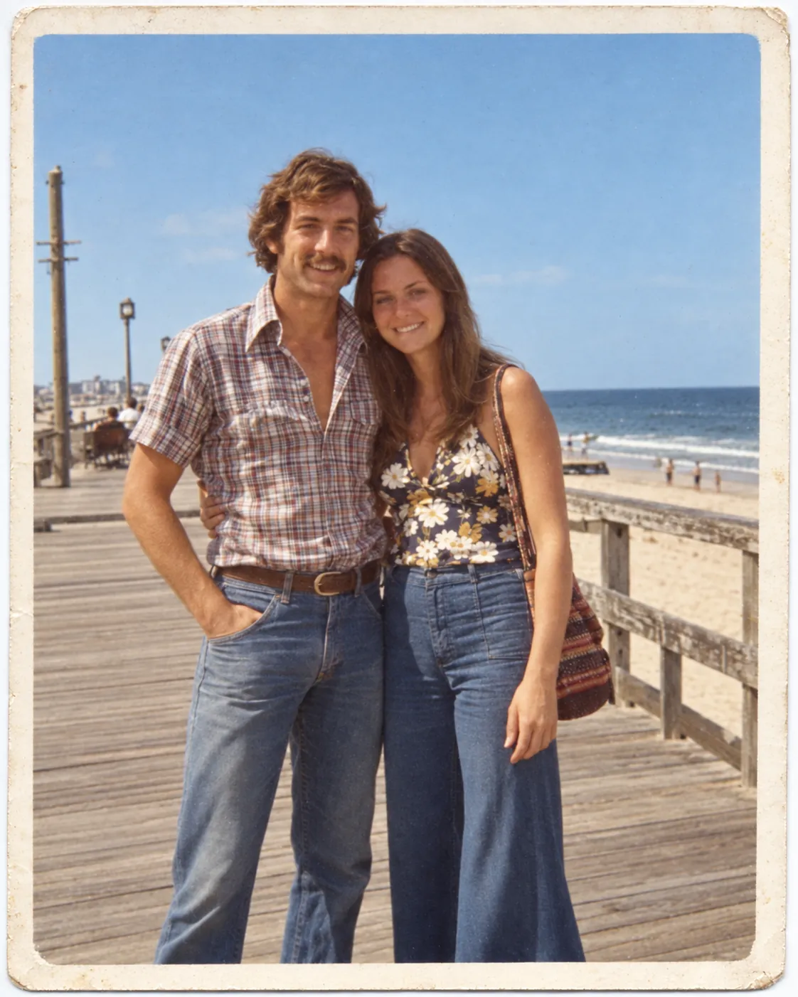 Repaired 1970s photo of a couple on a seaside boardwalk with natural color